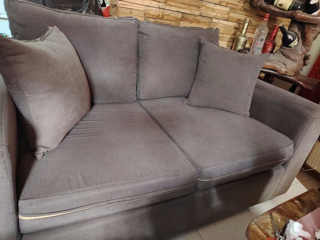 2-Seater Gray Sofa (Category: Sofas) located in Antipolo. Submitted by secondmusebags (Listing ID 1465421969, Image 2). Description: Bought for 20k+ 3 years ago Big 2-seater sofa with pillow and foam No lundo or uneven seat. Need cleaning only and has minor signs of usage on the side Courier/deliver must be shouldered by the buyer po Location; Mission Hills Antipolo City.