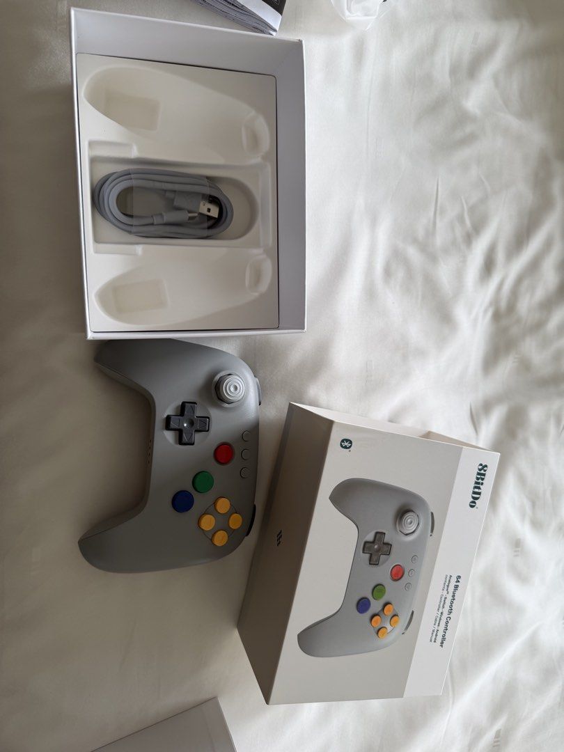 8BitDo 64 Bluetooth Controller Grey (Category: Controllers) located in Singapore. Submitted by yodamynameis (Listing ID 1465445514, Image 3). Description: - Model: 8BitDo 64 Bluetooth Controller (Grey) - Condition: Brand new, tested working - Compatibility: Analogue 3D, Nintendo Switch, Windows, and Android - Included: Original box, USB cable, and manual - Perfect retro-style gamepad for modern gaming setups Meet ups at amk station.