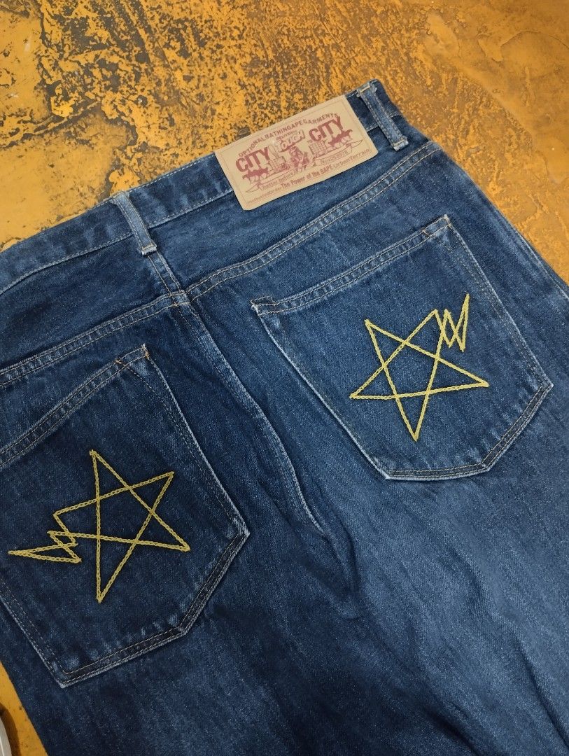 A Bathing Ape 1999 Type-02 Regular Denim Jeans (Category: Jeans) located in Manila. Submitted by niggzreyno51476 (Listing ID 1465448133, Image 2). Description: - Brand: A Bathing Ape (BAPE) 1999 Type-02 - Fit: Regular fit, classic straight leg silhouette - Color: Dark blue wash - Details: Distinctive star embroidery on back pockets and front coin pocket - Closure: Button fly construction - Branding: Branded leather patch with 'City to City' graph