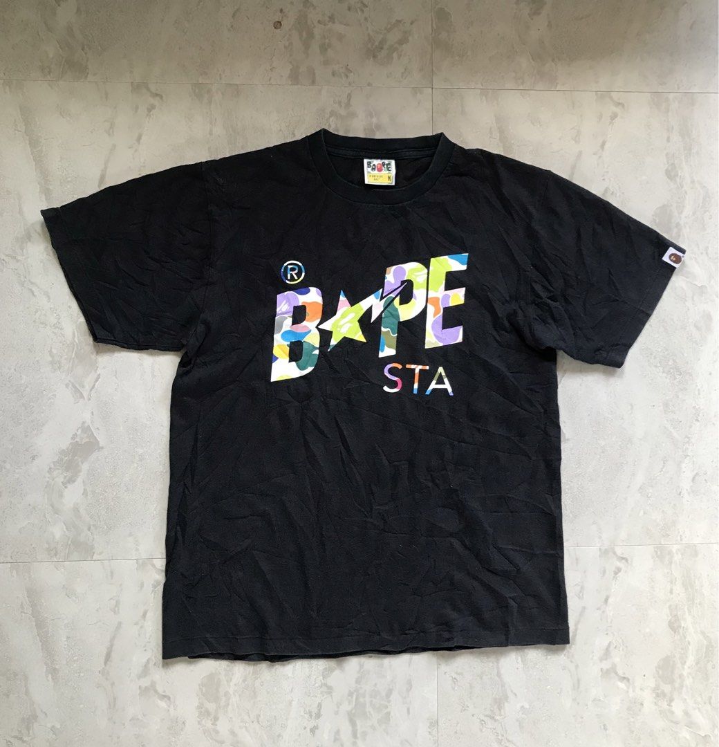 A Bathing Ape Bape Sta Black Tee Size M (Category: Tshirts & Polo Shirts ) located in Banga. Submitted by jorguarino (Listing ID 1465395933, Image 1). Description: - Authentic BAPE black t-shirt - Vibrant colorful BAPE STA graphic logo on the front - Size: Medium (fits true to size) - Material: Comfortable cotton with standard interior wash and care tags - Includes signature sleeve tag - Condition: Slight wear from regular use, well-maintained - 
