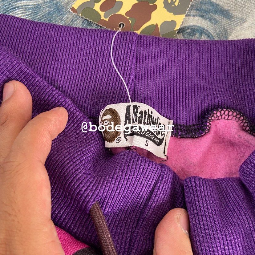 A Bathing Ape Purple Camo Shark Shorts (Category: Shorts) located in Manila. Submitted by bodegawear_mnl (Listing ID 1465409680, Image 3). Description: - Brand: BAPE (A Bathing Ape) - Item: Purple Camo Shark Sweat Shorts - Size: Small - Condition: Brand new with original tags attached - Features: Iconic shark face graphic with red/white teeth, soft fleece lining, drawstring waist, and back pocket with ape head tag - Authenticity: 100% authentic s