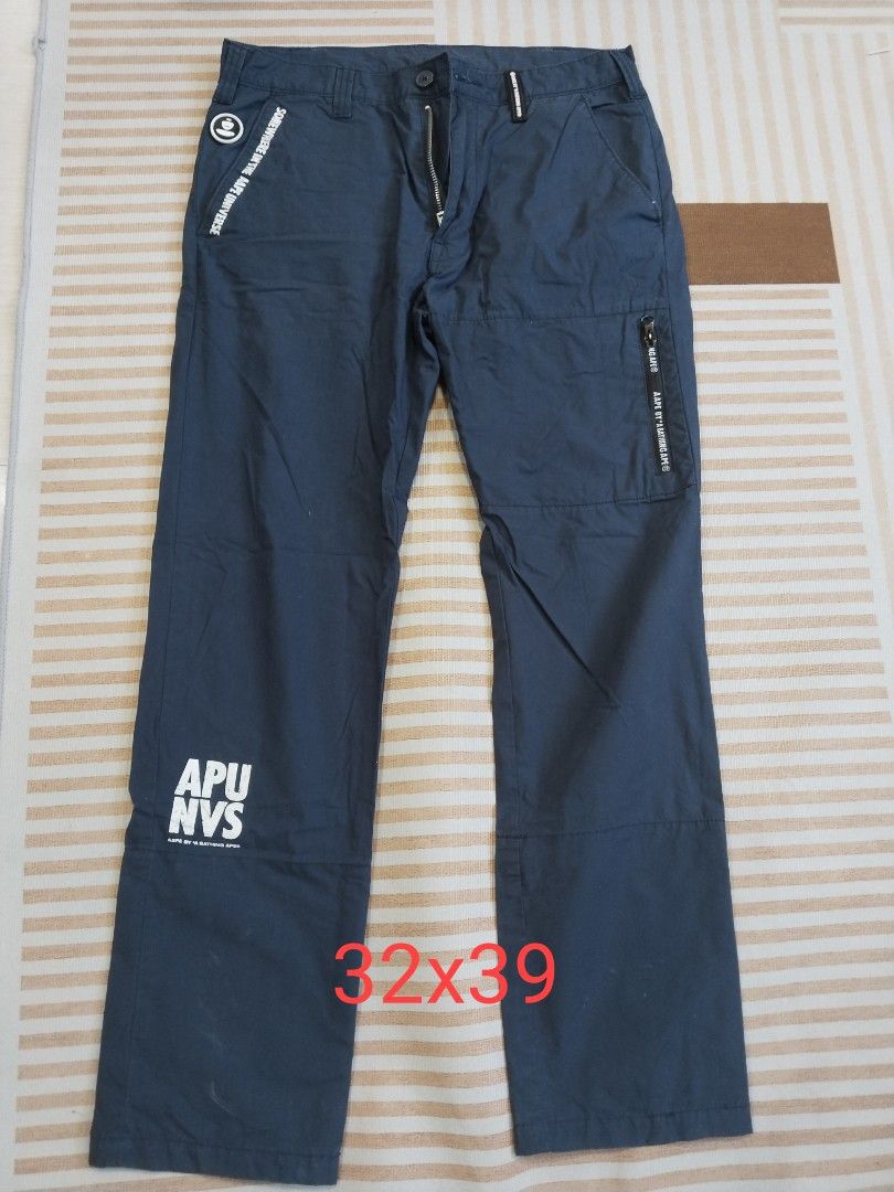 AAPE By A Bathing Ape Dark Blue Cargo Pants (Category: Joggers) located in Manila. Submitted by polding25 (Listing ID 1465385683, Image 1). Description: - Brand: AAPE by A Bathing Ape - Color: Dark Blue - Size: Tagged 175/82A (Roughly 32" waist by 39" length) - Design details: Graphic prints on right leg, zipper pocket on left thigh, and signature branding throughout - Construction: Standard button closure with zipped fly, clean multi-panel build