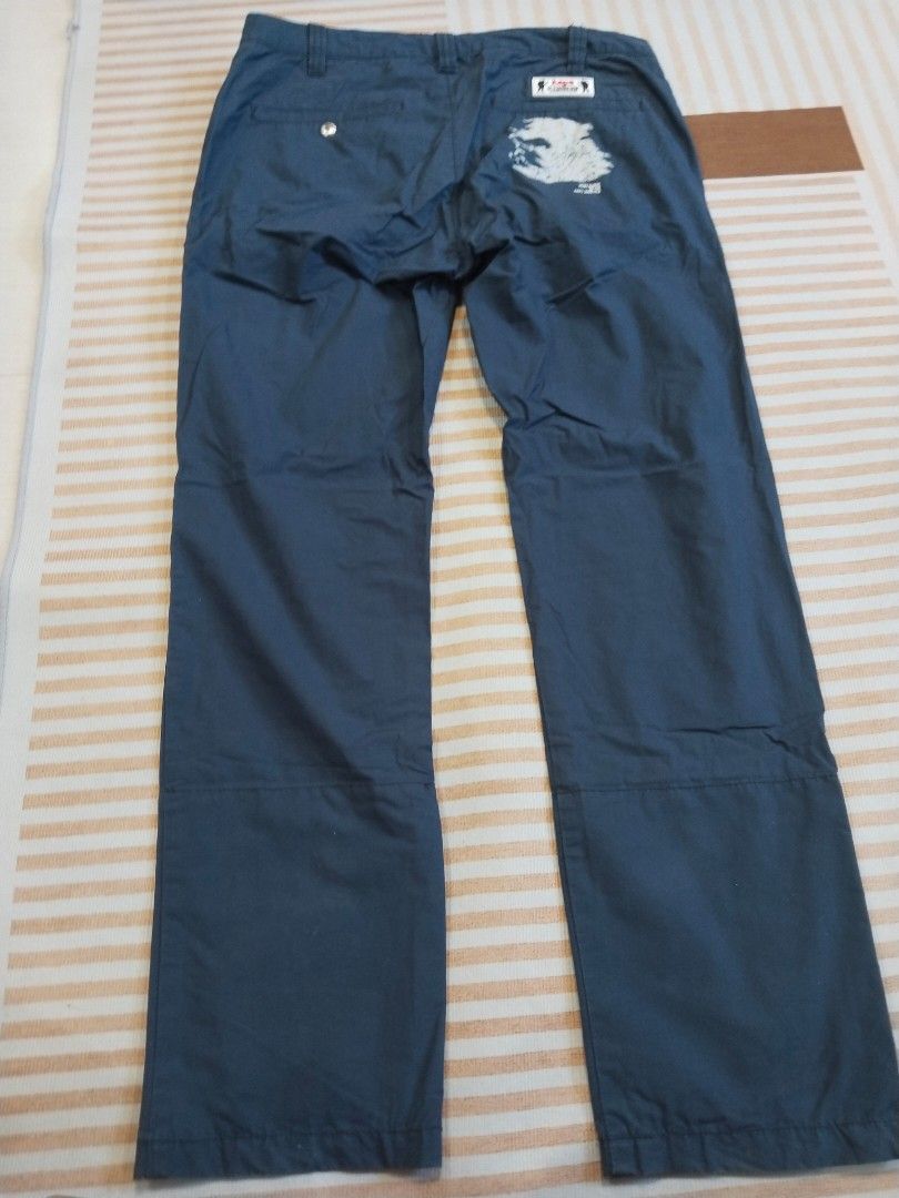 AAPE By A Bathing Ape Dark Blue Cargo Pants (Category: Joggers) located in Manila. Submitted by polding25 (Listing ID 1465385683, Image 2). Description: - Brand: AAPE by A Bathing Ape - Color: Dark Blue - Size: Tagged 175/82A (Roughly 32" waist by 39" length) - Design details: Graphic prints on right leg, zipper pocket on left thigh, and signature branding throughout - Construction: Standard button closure with zipped fly, clean multi-panel build