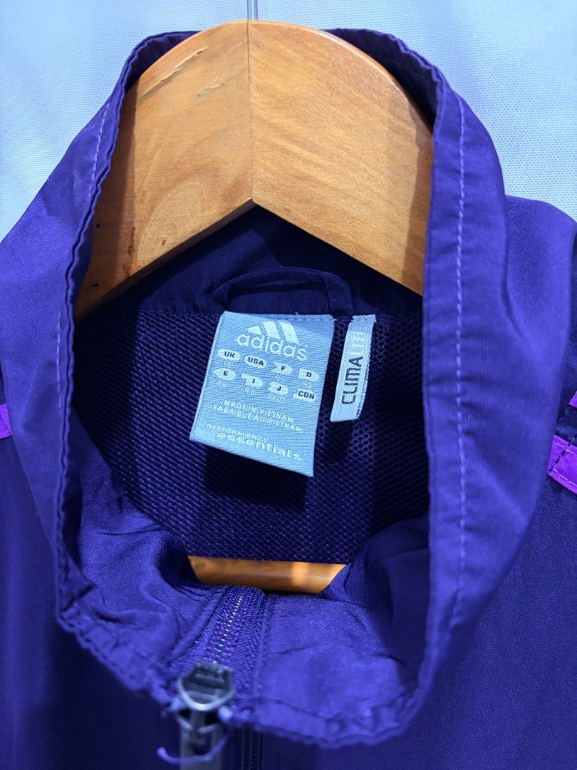 Adidas Climalite Purple Track Jacket (Category: Coats, Jackets and Outerwear) located in General Trias. Submitted by hayami.clo (Listing ID 1465386631, Image 2). Description: - Color: Deep purple with bright purple three-stripe branding - Fit: Women's sizing with embroidered Adidas chest logo - Closure: Full zip front with dual zippered side pockets - Lining: Breathable mesh inner lining throughout - Condition: Excellent, ready to wear.