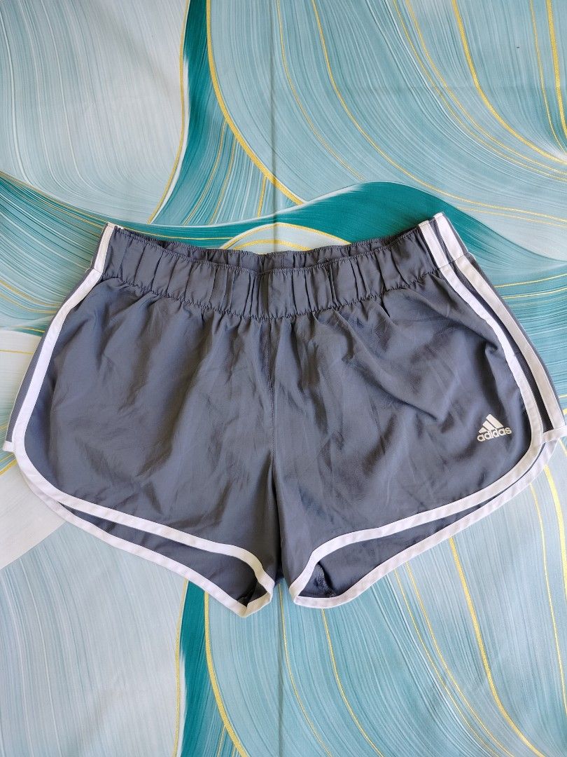 Adidas Gray Running Shorts Size Large (Category: Activewear) located in Manila. Submitted by gerald_quinto (Listing ID 1465481675, Image 1). Description: - Brand: Adidas -Size 30-40 - Color: Gray with white piping - Size: Large - Material/Features: Breathable mesh inner lining, elastic waistband for secure fit - Logo: Iconic white Adidas logo near the hem - Condition: Clean, excellent pre-loved condition.