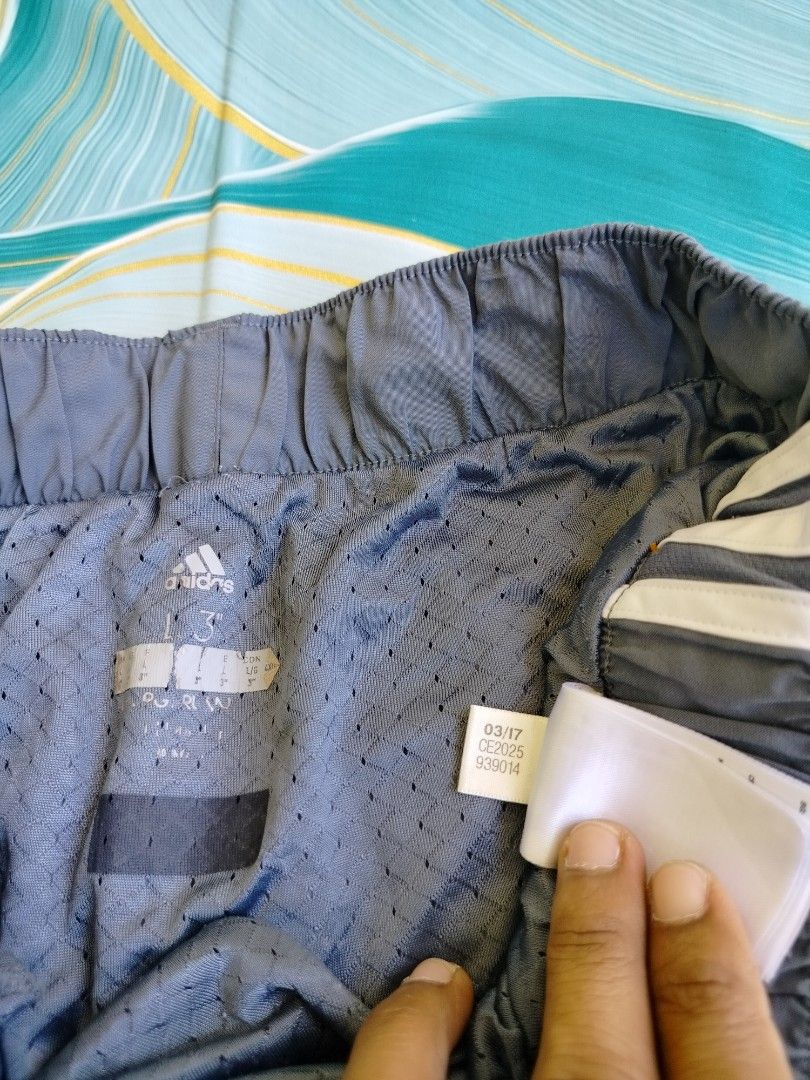Adidas Gray Running Shorts Size Large (Category: Activewear) located in Manila. Submitted by gerald_quinto (Listing ID 1465481675, Image 3). Description: - Brand: Adidas -Size 30-40 - Color: Gray with white piping - Size: Large - Material/Features: Breathable mesh inner lining, elastic waistband for secure fit - Logo: Iconic white Adidas logo near the hem - Condition: Clean, excellent pre-loved condition.