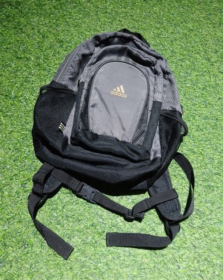 Adidas Mini grey and black backpack with mesh side pockets (Category: Backpacks) located in Manila. Submitted by patrickjos06722 (Listing ID 1465491550, Image 1). Description: - Authentic grey and black Adidas backpack with a stylish geometric pattern - Comfortable padded back panel and adjustable shoulder straps for daily use - Secure chest buckle for added support during commutes - Convenient front zipped pocket and dual side mesh pockets for w