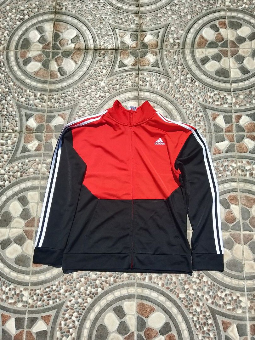Adidas Red Black Track Jacket (Category: Coats, Jackets and Outerwear) located in Cabuyao City. Submitted by kyokiiiiiii (Listing ID 1465429674, Image 1). Description: - Brand: Adidas - Color: Red, black, and white - Design: Color-blocked with signature white stripes down both sleeves - Features: Full zip front, stand-up collar, ribbed cuffs and hem - Style: Classic athletic streetwear - Condition: Excellent / ready to wear.