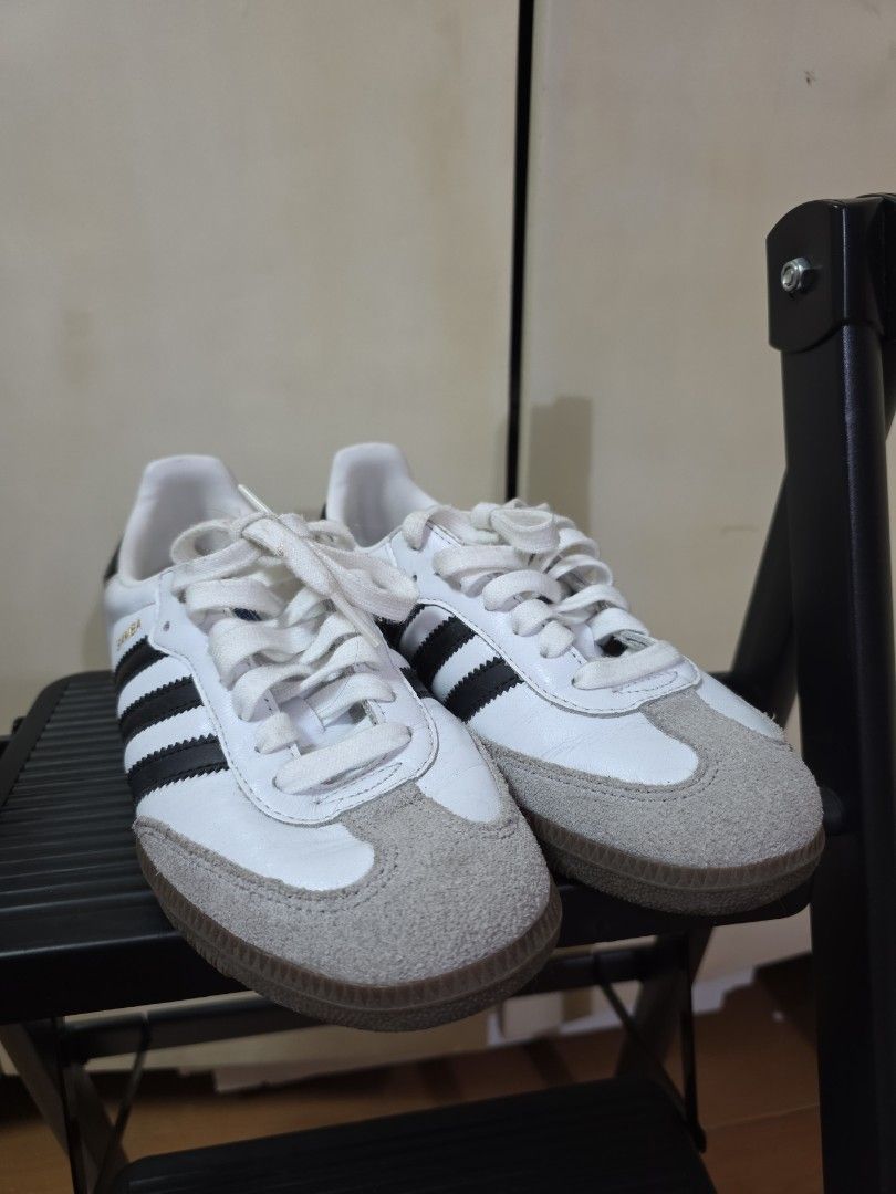Adidas Samba White Black Leather Sneakers (Category: Sneakers) located in Quezon City. Submitted by buysophie (Listing ID 1465402504, Image 1). Description: - Model: Adidas Samba - Colorway: White leather with classic black stripes and gum soles - Details: Grey suede toe caps and white laces - Style: Iconic retro indoor soccer design, perfect for everyday streetwear rfs: too small on me - Condition: Clean uppers with slight wear on the laces.