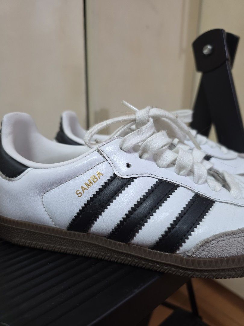 Adidas Samba White Black Leather Sneakers (Category: Sneakers) located in Quezon City. Submitted by buysophie (Listing ID 1465402504, Image 2). Description: - Model: Adidas Samba - Colorway: White leather with classic black stripes and gum soles - Details: Grey suede toe caps and white laces - Style: Iconic retro indoor soccer design, perfect for everyday streetwear rfs: too small on me - Condition: Clean uppers with slight wear on the laces.