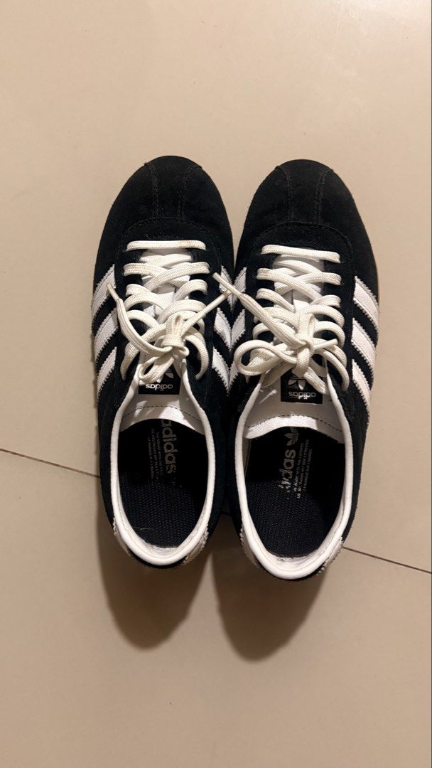 Adidas Tokyo Black White Sneakers (Category: Sneakers) located in Quezon City. Submitted by bea3s (Listing ID 1465486894, Image 3). Description: - Brand/Model: Adidas Classic Black Suede Sneakers - Details: White stripes, white laces, and iconic gold Tokyo lettering on the side - Sole: Durable gum rubber sole with minimal wear - Interior: White leather collar with Adidas trefoil logo on the tongue and insole - Condition: Clean overall, well-maint