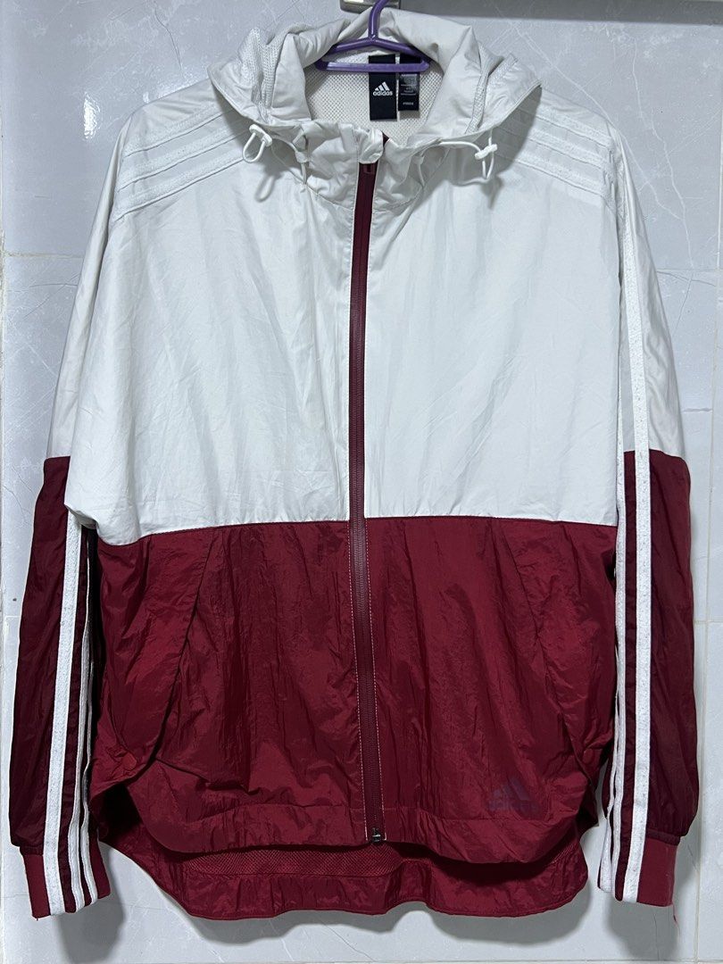 Adidas White and Maroon Windbreaker Jacket (Category: Coats, Jackets and Outerwear) located in Manila. Submitted by jj0451315 (Listing ID 1465492773, Image 3). Description: - Brand: Adidas - Style: Zip-up windbreaker with hood - Color: White on top, maroon on bottom with classic white three stripes on sleeves - Size: Small (S) - Lining: Breathable inner mesh lining - Features: Adjustable hood drawstrings - Ideal for: Workouts, casual wear, and br