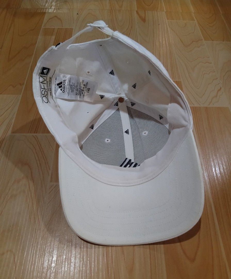 Adidas White Baseball Cap OSFM (Category: Caps & Hats) located in San Jose del Monte. Submitted by azetor (Listing ID 1465578883, Image 2). Description: - Color: Clean White with Black Embroidered Adidas Logo - Size: One size fits most (Adjustable strap at the back with iconic 3-stripes tab) - Material: Lightweight, breathable fabric with interior sweatband - Origin: Made in China with model code on inner tag - Condition: great condition .
