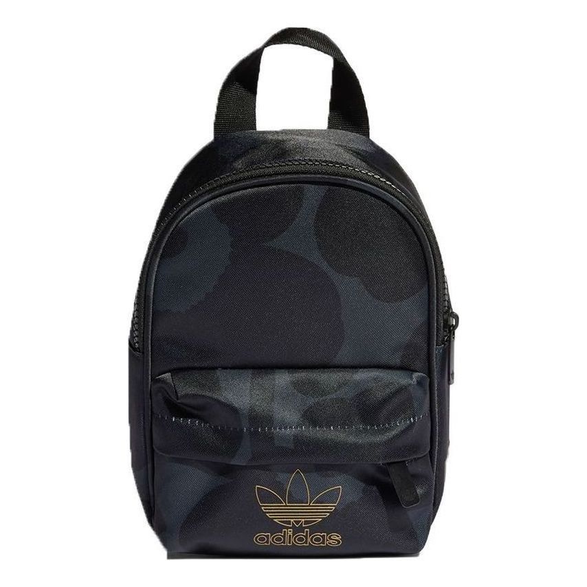 Adidas x Marimekko Mini Backpack Black Gold (Category: Backpacks) located in Pasig City. Submitted by nakamuraka (Listing ID 1465397739, Image 2). Description: Adidas and Marimekko collaboration mini backpack. Black colorway featuring the iconic poppy print pattern throughout. Gold foil trefoil logo on the front pocket and branding tag on the side. Front zippered pouch pocket, main zip compartment, and adjustable shoulder straps. Compact size, gr