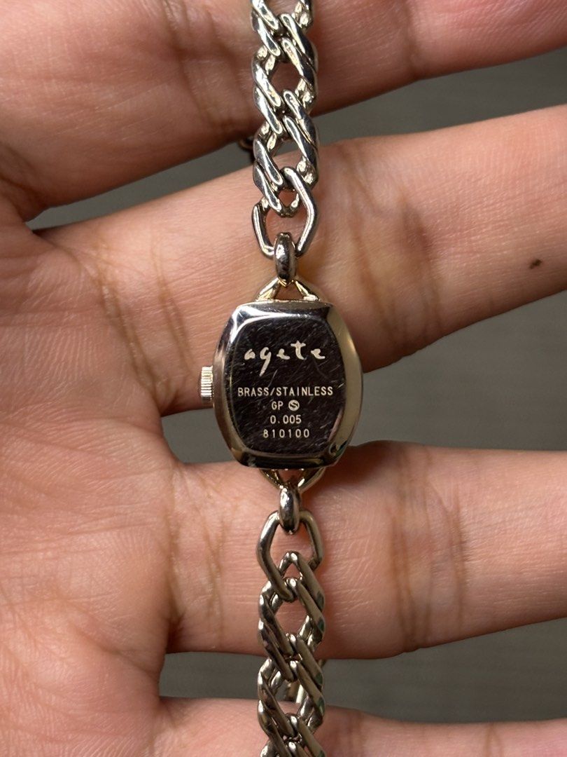 Agete Chain Jewelry Watch (Category: Women's Watches) located in Manila. Submitted by soughtafterseconds (Listing ID 1465440802, Image 3). Description: Agete Chain Jewelry Watch This Agete Dainty Mother-of-Pearl & Diamond Gold-Tone Chain Jewelry Watch is a delicate, high-end piece of Japanese boutique jewelry horology, blending Art Deco geometry with an intricate curb-link chain bracelet. A mini tonneau-shaped gold-plated case framed by an intric