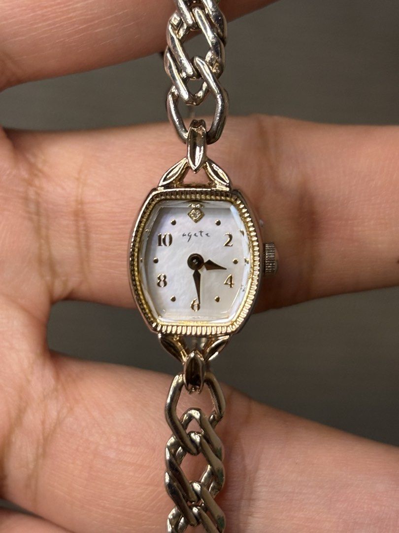 Agete Chain Jewelry Watch (Category: Women's Watches) located in Manila. Submitted by soughtafterseconds (Listing ID 1465440802, Image 1). Description: Agete Chain Jewelry Watch This Agete Dainty Mother-of-Pearl & Diamond Gold-Tone Chain Jewelry Watch is a delicate, high-end piece of Japanese boutique jewelry horology, blending Art Deco geometry with an intricate curb-link chain bracelet. A mini tonneau-shaped gold-plated case framed by an intric