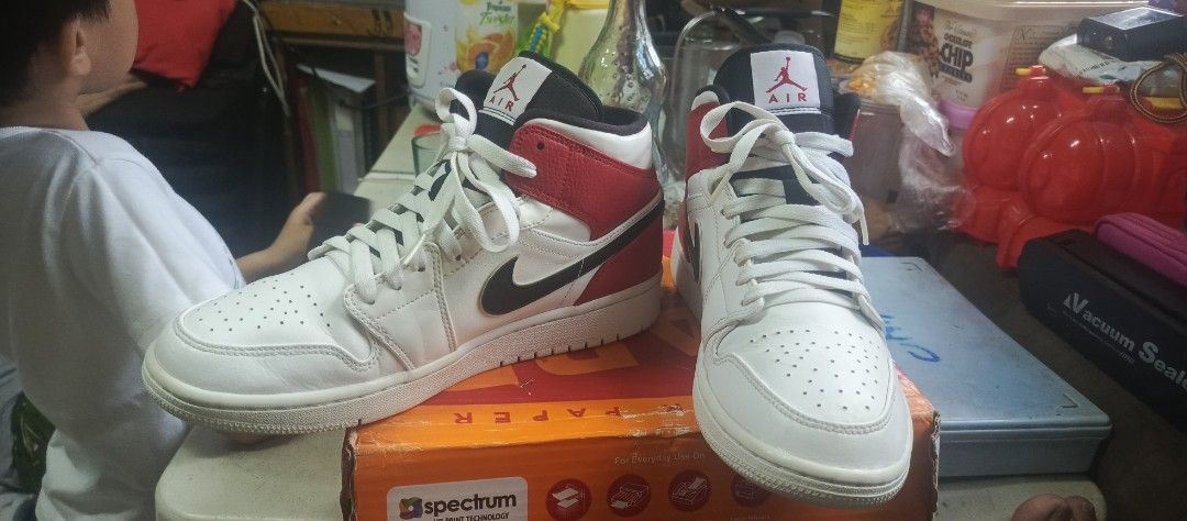 Air Jordan 1 Mid Chicago Black Toe (Category: Dress Shoes) located in Manila. Submitted by calditocas36230 (Listing ID 1465519975, Image 1). Description: - Model: Air Jordan 1 Mid - Colorway: Chicago Black Toe (White leather base, black swooshes, red overlays) - Branding: Red Jumpman logo on tongue tags - Details: White laces and clean white rubber outsoles - Condition: Minor creasing on toe boxes from normal wear - 100% authentic and well-mainta