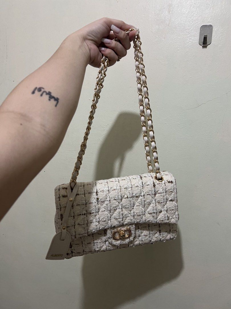 Chain Bag (Category: Shoulder Bags) located in Caloocan City. Submitted by themsizzavelleeee (Listing ID 1465527554, Image 1). Description: - Brand: Alberto - Color: Cream neutral (matches any outfit) - Material: Tweed fabric with quilted diamond pattern - Strap: Interwoven gold and leather chain - Closure: Turn-lock front hardware - Condition/Inclusions: Clean structured shape, includes Alberto branded hanging tag.