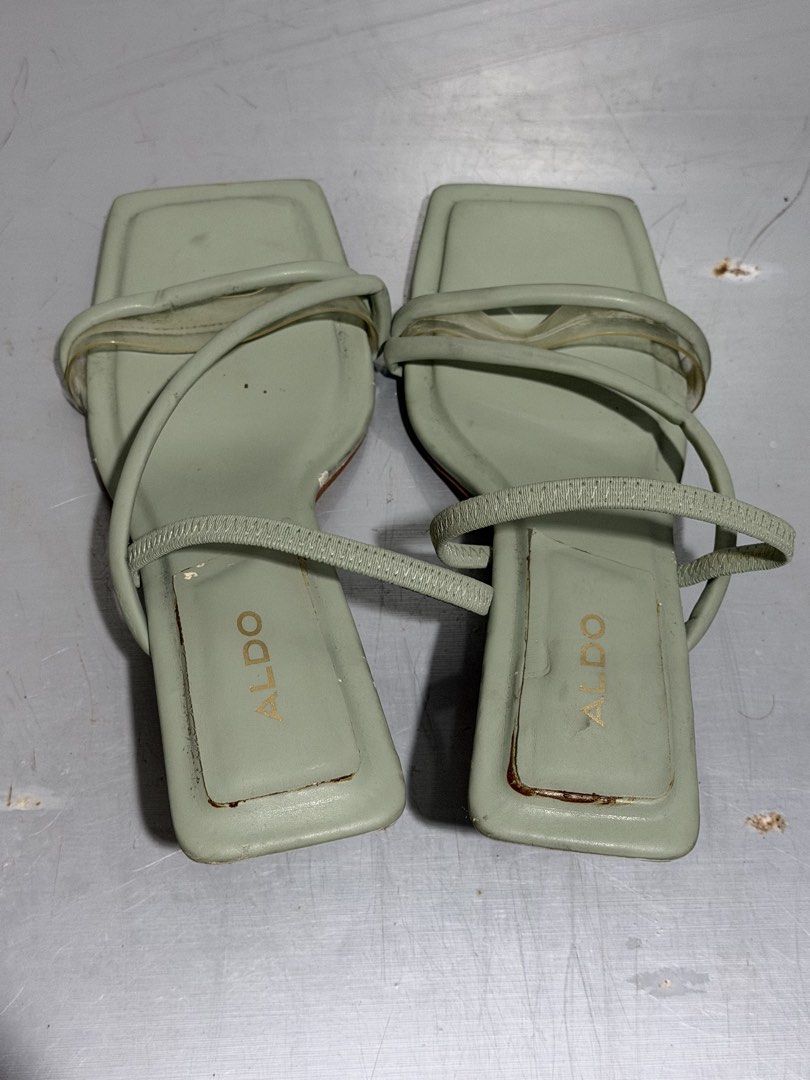 ALDO Sage Green Square Toe Heels Size 38 (Category: Heels) located in Santa Rosa. Submitted by leana_yna (Listing ID 1465486633, Image 2). Description: - Brand: ALDO - Style: Sage green mules with clear toe straps and square toe - Heel: Kitten heel - Size: US 7.5 / EUR 38 / UK 5 - Condition: Normal wear on soles; minor peeling and scuffing on the heel wrap as shown in photos.