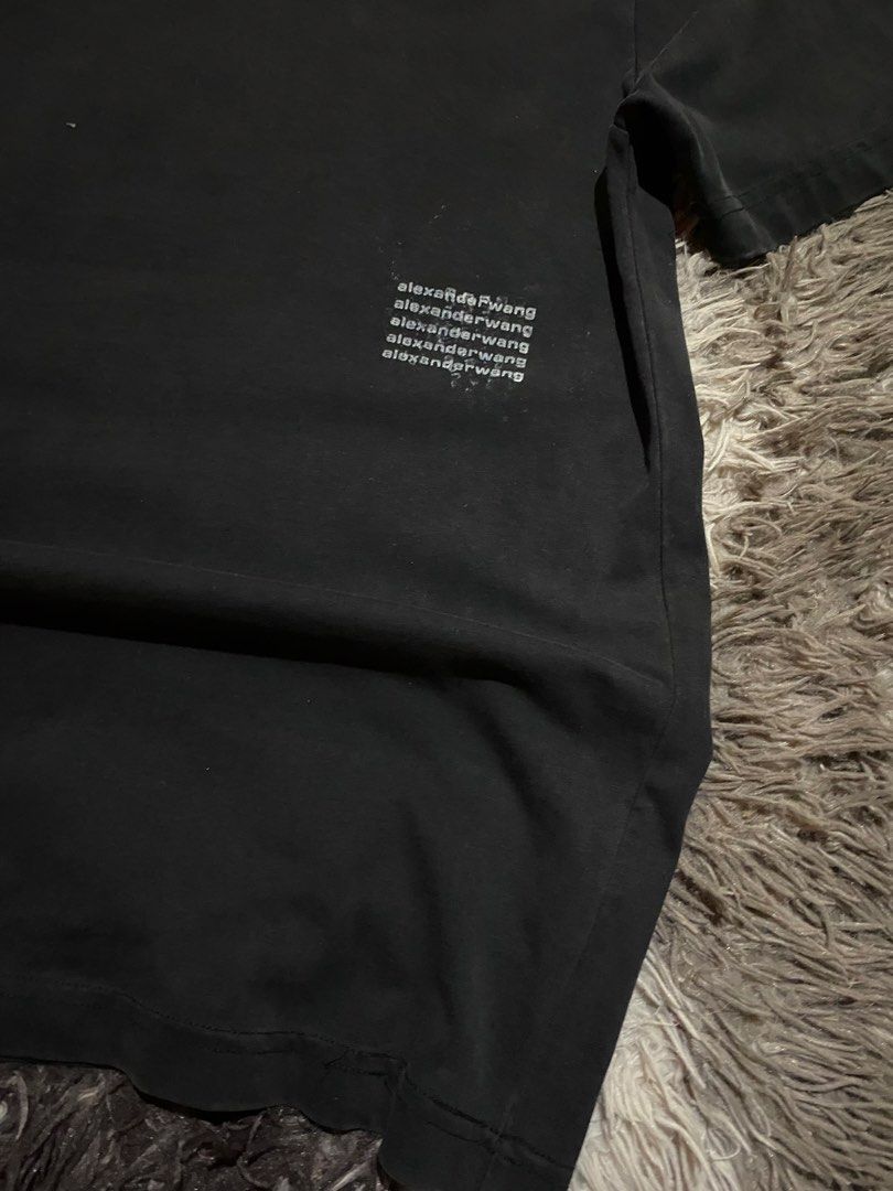 Alexander Wang black t-shirt size M (Category: Shirts) located in Caloocan City. Submitted by remythrift (Listing ID 1465416975, Image 2). Description: - Brand: Alexander Wang - Size: Medium (Regular fit) - Material: 100% Cotton (Made in Vietnam) - Design: Classic crewneck, short sleeves, subtle stacked logo print near the lower front hem - Condition: Shows gentle, even fading consistent with regular wear - Style: Versatile and easy to match with