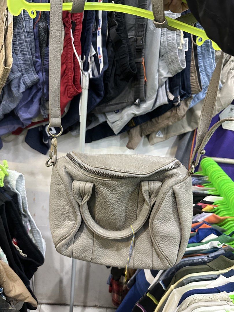 Alexander Wang Grey Leather Crossbody Bag (Category: Cross-body Bags) located in Daet. Submitted by thrifthings2018 (Listing ID 1465481549, Image 1). Description: - Brand: Alexander Wang - Material: Premium grey pebbled leather - Closure: Top zip with edgy zip detailing - Handles: Two rolled carry handles + removable/adjustable crossbody strap - Interior: Black fabric lining with multiple slip pockets and one zip pocket - Condition: Excellent / W