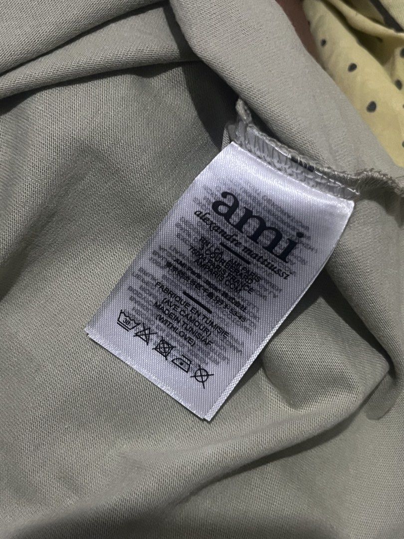 Ami (Category: Shirts) located in Manila. Submitted by _kayeanne (Listing ID 1465572525, Image 3). Description: - Brand: Ami Alexandre Mattiussi - Color: Sage Green - Size: Large (M-L) - Design: Embroidered AMI heart logo on chest and AMI lettering at the back - Condition: 4/5 well-maintained - Material: Soft, breathable cotton blend ideal for daily use.
