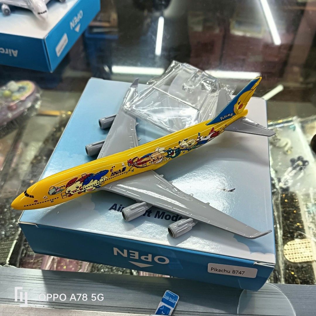 ANA Pokémon Pikachu B747 Aircraft Model with Box (Category: Vehicle & Diecast Models) located in Manila. Submitted by iliasjen3082126 (Listing ID 1465517361, Image 1). Description: - ANA Pokémon Pikachu B747 model plane in vibrant yellow with grey wings and engines - Features eye-catching colorful cartoon graphics along the fuselage - Includes the original blue and white collector's display box - Comes with a clear plastic display stand, still se