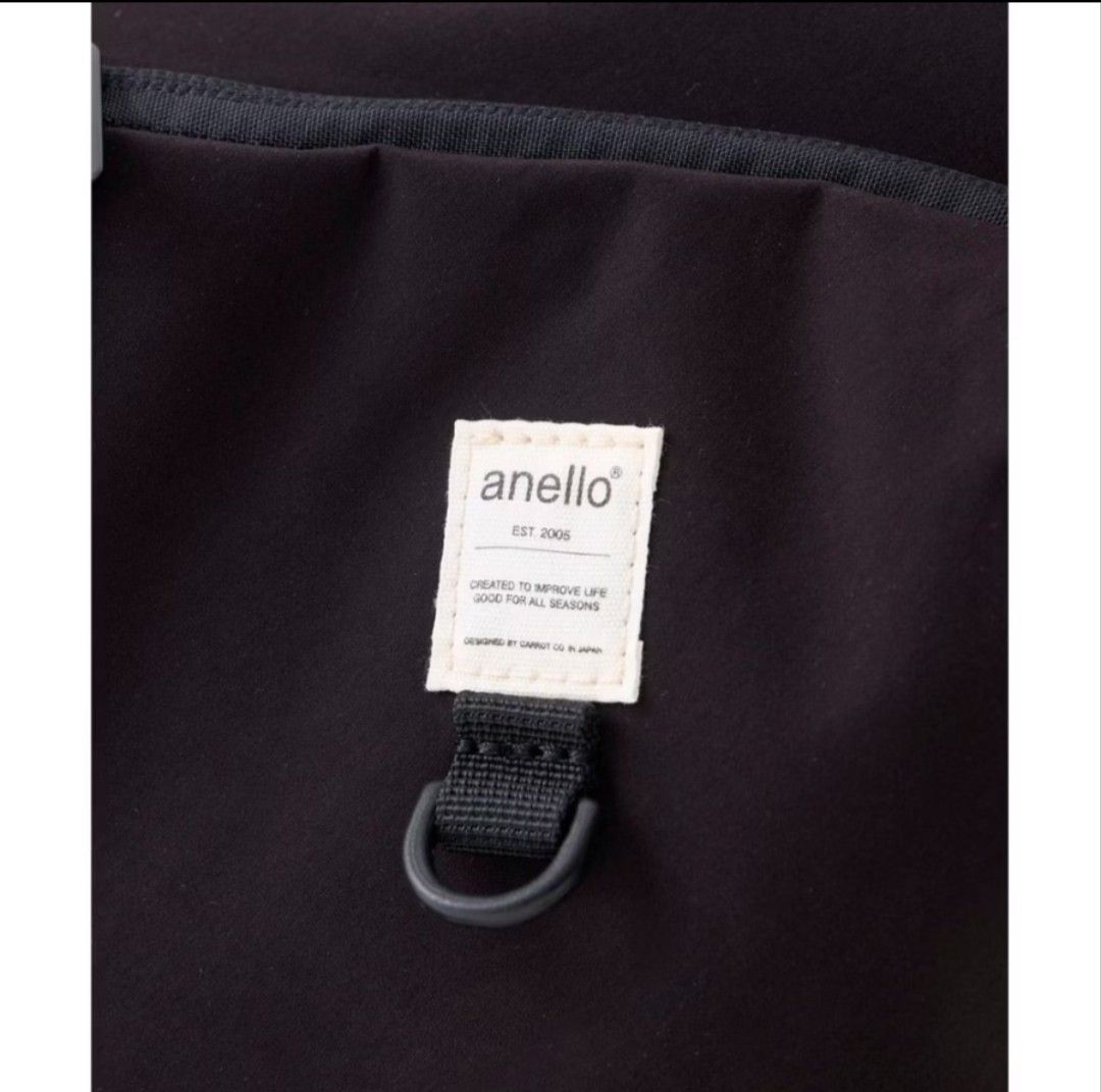 Preloved Anello Black Shoulder Bag with Front Pockets (Category: Cross-body Bags) located in Manila. Submitted by jen_corner (Listing ID 1465396182, Image 2). Description: Black anello shoulder bag with adjustable strap. Dual zipped front pockets include a woven brand patch and d-ring hardware. Main compartment opens wide with interior pockets and slip dividers for organization. Elasticated side pockets hold small bottles or umbrellas. Flat reinf