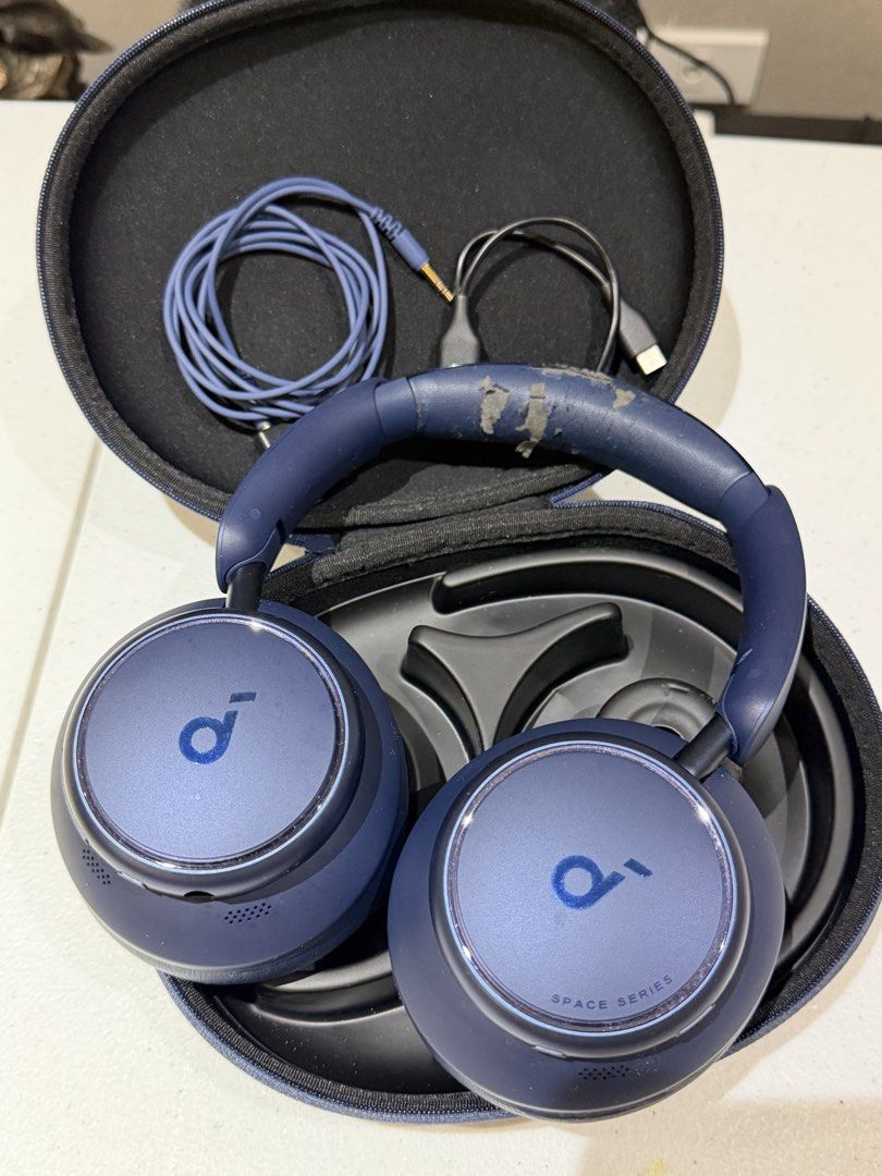 Anker Soundcore Space One Headphones (Category: Headphones & Headsets) located in Quezon City. Submitted by zyllus30 (Listing ID 1465493258, Image 1). Description: - Model: Anker Soundcore Space One Over-Ear Headphones - Color: Navy Blue - Condition: Fully functional audio and Active Noise Cancelling (ANC), but with heavy peeling/flaking on the synthetic leather ear pads and headband padding - Inclusions: Original hard carrying case, audio cable,