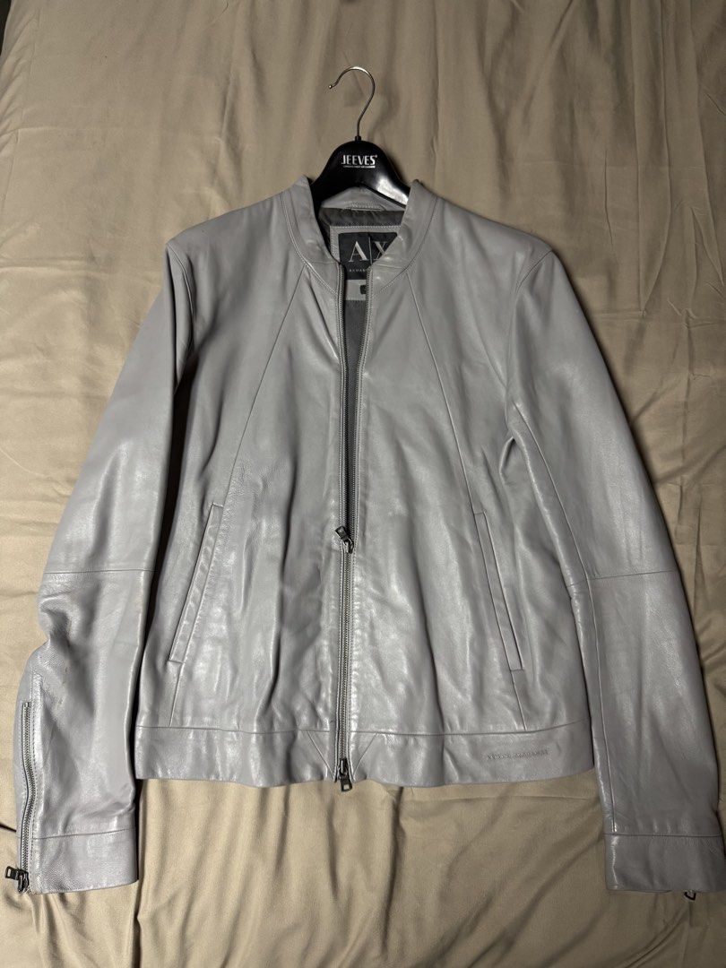 Armani Exchange Grey Leather Jacket Size M (Category: Coats, Jackets and Outerwear) located in Manila. Submitted by seangoart (Listing ID 1465507763, Image 1). Description: - Brand: Armani Exchange - Color: Grey - Size: M - Origin: Made in India - Material: Smooth leather with clean interior lining - Closure: Full front zip with branded hardware - Features: Zipped cuffs, vertical side pockets, and structured paneling.