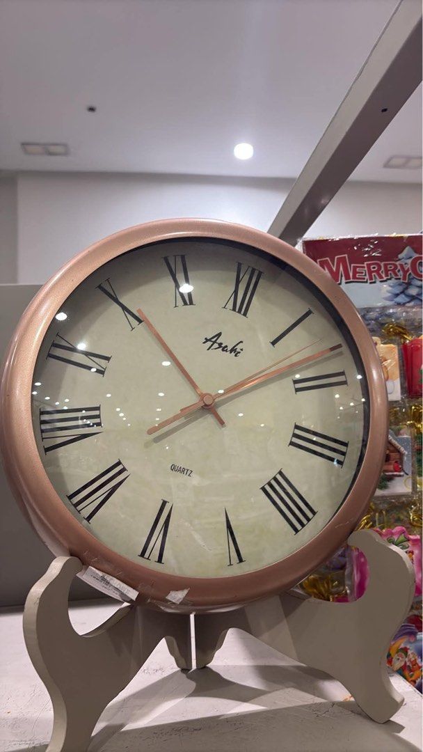 Asahi Rose Gold Quartz Wall Clock Roman Numerals (Category: Clocks) located in Bacoor. Submitted by tin_02 (Listing ID 1465523114, Image 1). Description: - Brand: Asahi - Design: Round wall clock in a chic rose gold finish - Dial: Light cream face with bold black Roman numerals and slim rose gold hands - Movement: Reliable quartz movement - Condition: Clean front glass and sturdy frame - Perfect for living rooms, bedrooms, or office spaces.