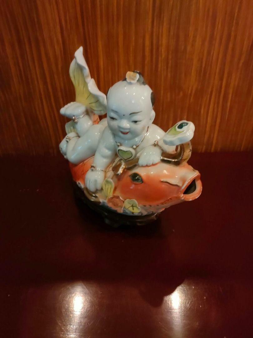 Asian Lucky Koi ceramic figurine set with boy (Category: Figurines & Statues) located in Caloocan City. Submitted by rise-edge (Listing ID 1465456961, Image 3). Description: - Stunning Asian Lucky Koi ceramic decor set - Includes a large piece with a resting boy on a koi, a tall leaping koi, and a small companion figurine - Features vibrant bright orange, white, and elegant gold accents - Mounted on a traditional dark wooden base - Ideal display 