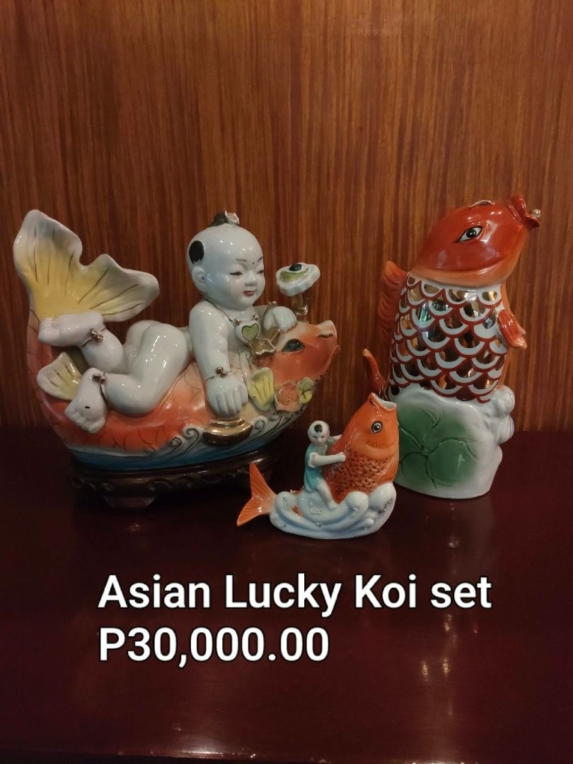 Asian Lucky Koi ceramic figurine set with boy (Category: Figurines & Statues) located in Caloocan City. Submitted by rise-edge (Listing ID 1465456961, Image 1). Description: - Stunning Asian Lucky Koi ceramic decor set - Includes a large piece with a resting boy on a koi, a tall leaping koi, and a small companion figurine - Features vibrant bright orange, white, and elegant gold accents - Mounted on a traditional dark wooden base - Ideal display 