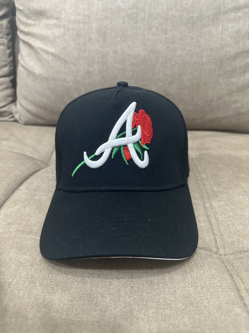 Atlanta Braves Rose Custom Snapback Hat (Category: Caps & Hats) located in Manila. Submitted by royal_vintage_thriftshop (Listing ID 1465491514, Image 2). Description: - Black snapback cap with embroidered Atlanta Braves 'A' logo - Features a unique red rose and green stem design on the front - Commemorative 2000 All-Star Game side patch - Structured crown with a flat brim - Adjustable plastic snap closure for a customizable fit.