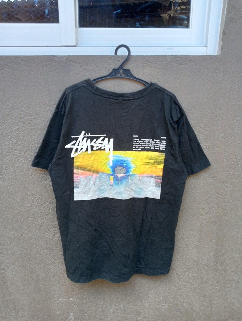 Authentic Stussy StoneHenge 2020 AD Graphic Tee Black Medium (Category: Tshirts & Polo Shirts ) located in Manila. Submitted by trifted.lootsph (Listing ID 1465398078, Image 2). Description: authentic StoneHenge Black Stussy graphic tee from the Hiver 2020 AD collection. Features colorful artwork on the front chest and a larger landscape graphic with branding text on the back. Short sleeves, classic crew neck. Tagged size medium, made in Mexico. 