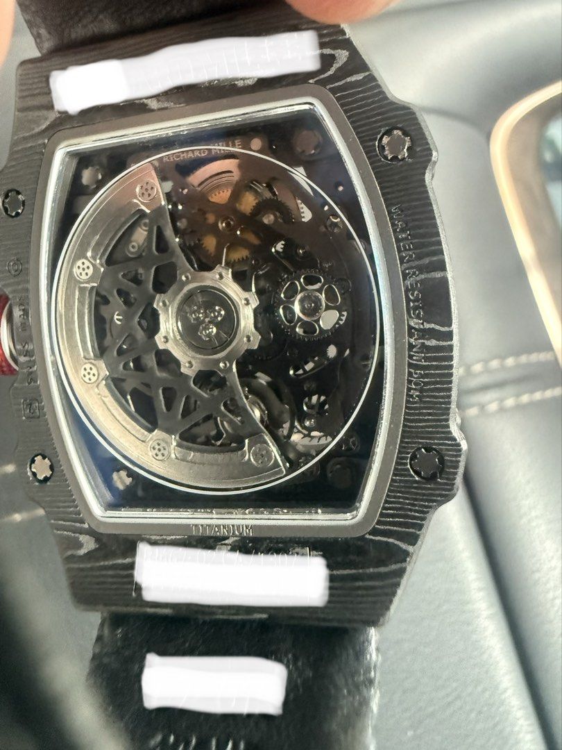 Automatic watch (Category: Watches) located in Singapore. Submitted by rareearth-e1ac (Listing ID 1465403276, Image 3). Description: Automatic Thin Watch 39mm - Case: Lightweight Black NTPT Carbon with exhibition case back. - Dial: Skeleton dial featuring a yellow inner flange, red and yellow graphic accents. - Movement: automatic movement with moving gear at 7oclock. - Strap: Textured black strap with a subtle red crown detail. - Deal method: Me