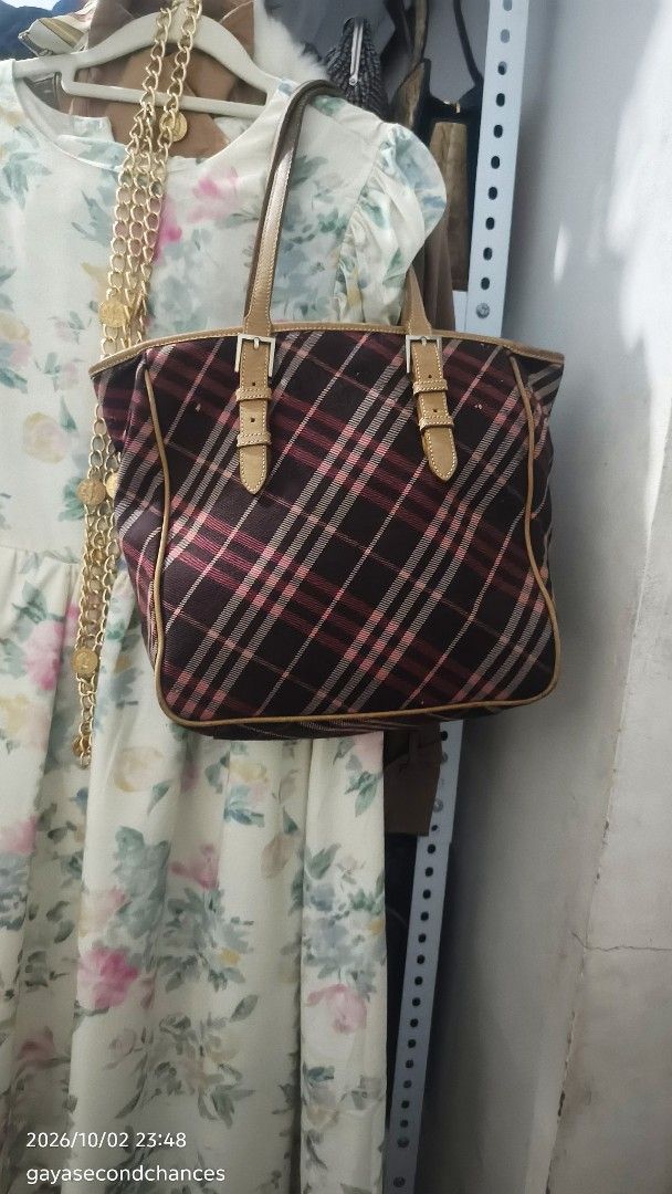 B URBERRY BLUE LABEL PLAID BAG (PROJECT/JUNK) (Category: Tote Bags) located in Kalibo. Submitted by secondchances.thriftsh8p (Listing ID 1465529964, Image 3). Description: - Authentic Burberry Blue Label tote bag - Classic plaid check pattern with brown leather trim - Dual top handles with stylish front buckled strap details - Secure top zip closure with a spacious main compartment - Blue interior lining featuring the Burberry London Blue Label b