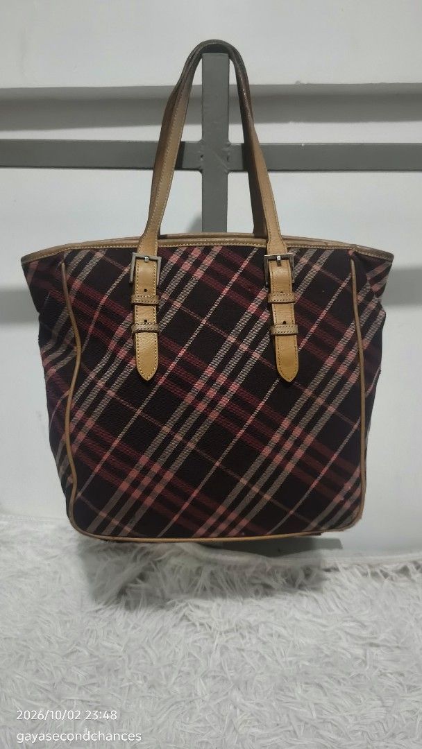 B URBERRY BLUE LABEL PLAID BAG (PROJECT/JUNK) (Category: Tote Bags) located in Kalibo. Submitted by secondchances.thriftsh8p (Listing ID 1465529964, Image 2). Description: - Authentic Burberry Blue Label tote bag - Classic plaid check pattern with brown leather trim - Dual top handles with stylish front buckled strap details - Secure top zip closure with a spacious main compartment - Blue interior lining featuring the Burberry London Blue Label b