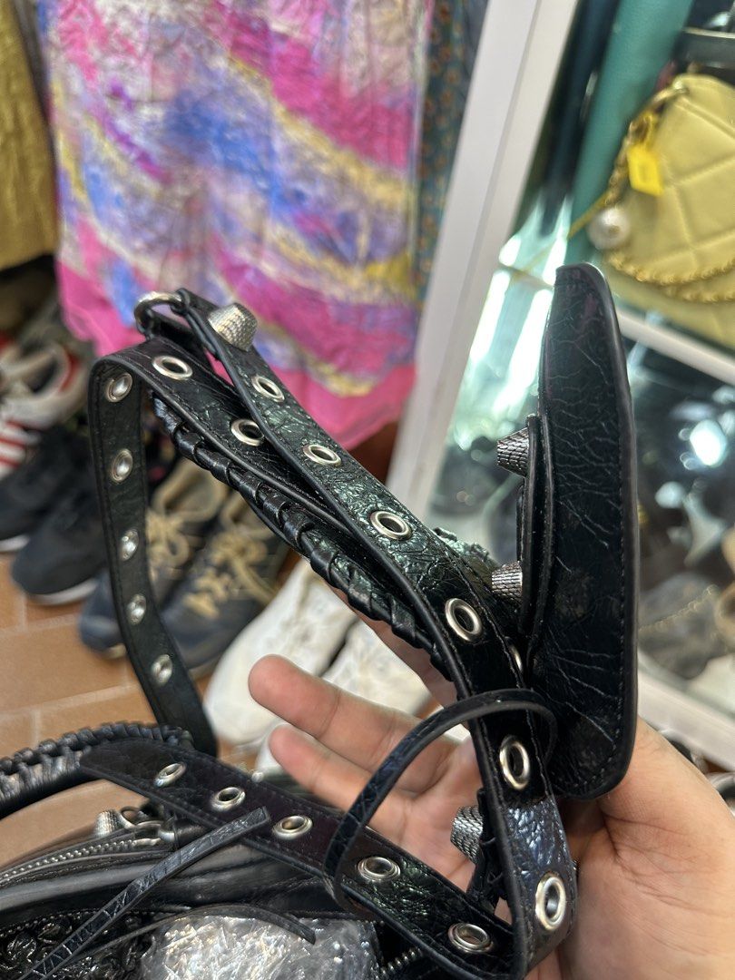 Balenciaga Black City Handbag (Category: Luxury Bags & Wallets) located in Daet. Submitted by thrifthings2018 (Listing ID 1465482056, Image 3). Description: - Edgy silver hardware, studs, and signature double BB logo zip pullers - Versatile carry options with dual rolled top handles and a matching shoulder strap - Secure top zip closure with exterior front zip pocket - Black fabric-lined interior featuring an inner zippered pocket - Iconic motorc