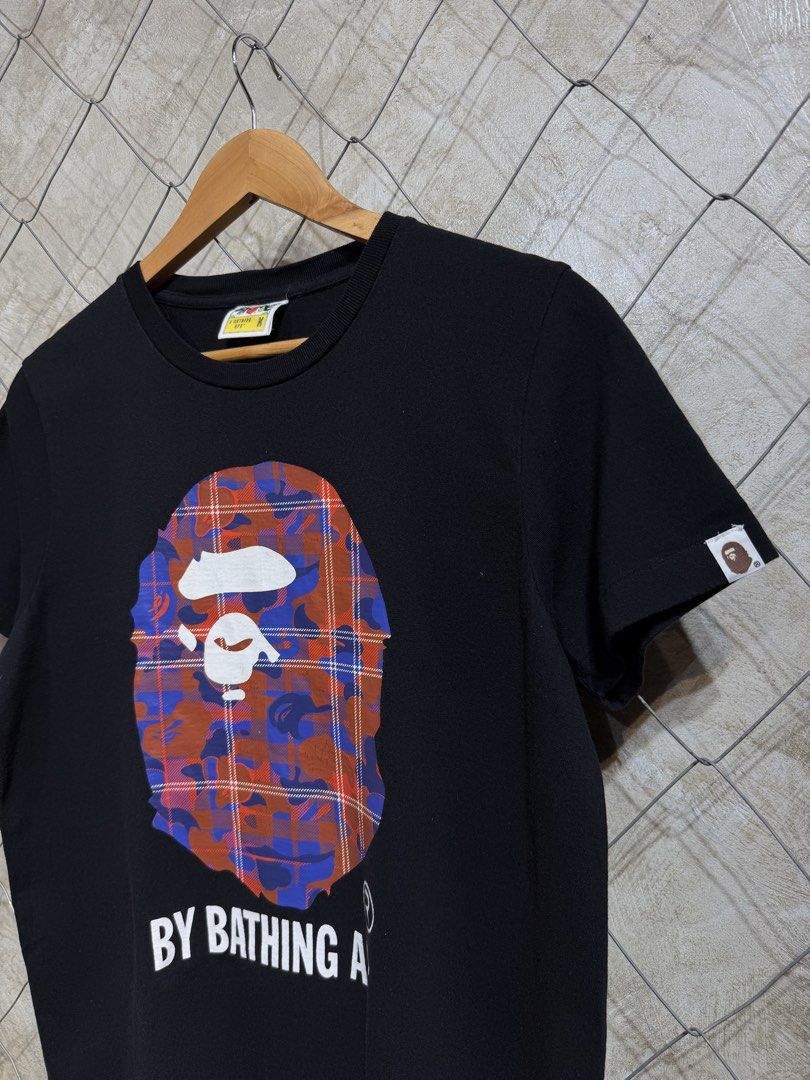 BAPE A Bathing Ape Plaid Camo Ape Head Tee (Category: Shirts) located in Manila. Submitted by ardobe.mnl (Listing ID 1465534743, Image 2). Description: Bape Plaid Bighead Logo Black Tee. Size: Large - Women’s (Women’s cut) Dimes: 20.5x27 Condition: Excellent Flaw: Minimal Hairline crack! Dm for inquiries! 📥.