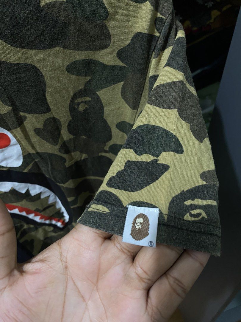BAPE Shark Camo Split Tee Black Green Size XL (Category: Tshirts & Polo Shirts ) located in Butuan. Submitted by nielben13 (Listing ID 1465392112, Image 3). Description: - Brand: BAPE (A Bathing Ape) - Item: Split Shark Tee - Colorway: Black / Green Camo - Size: Med to Large - Details: Classic front shark graphic, vertical WGM lettering on the back, and Ape head sleeve tag - Issue Cut tags .