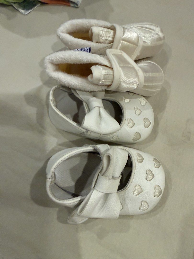Baptism Baby White Shoes (Category: Babies & Kids Fashion) located in Paranaque City. Submitted by ammmt (Listing ID 1465413353, Image 2). Description: - Bundle of 2 pairs of cute white baby shoes - Pair 1: Features embroidered white hearts on the toe and a large matching front bow - Pair 2: Soft fabric booties with a secure strap and Pitter Pat brand tag inside - Designed specially for tiny infant feet - Great and versatile addition to any baby 