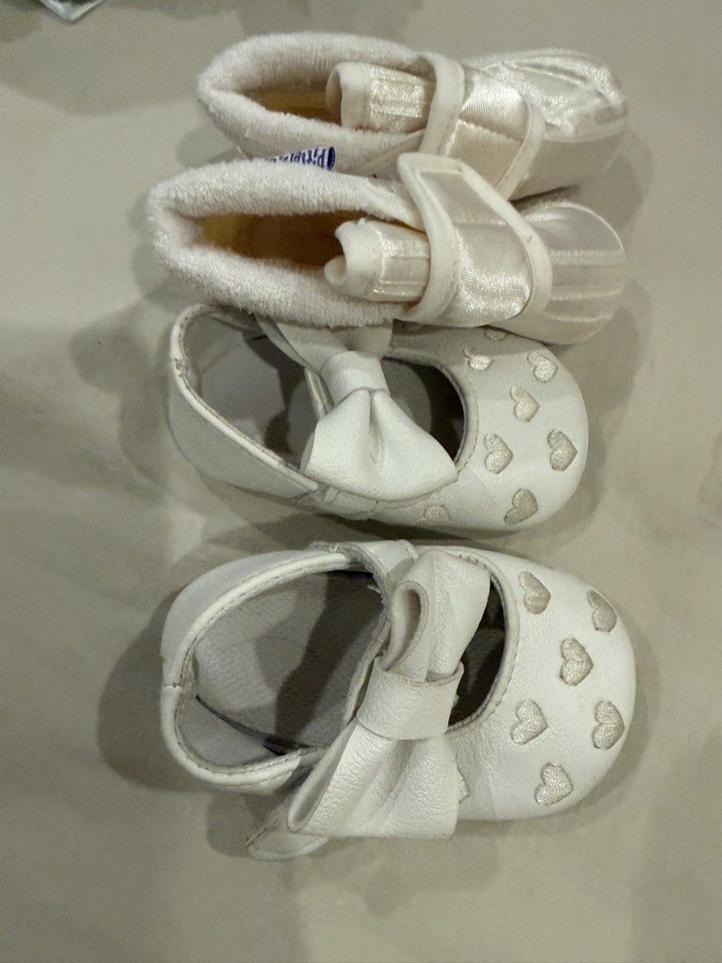 Baptism Baby White Shoes (Category: Babies & Kids Fashion) located in Paranaque City. Submitted by ammmt (Listing ID 1465413353, Image 3). Description: - Bundle of 2 pairs of cute white baby shoes - Pair 1: Features embroidered white hearts on the toe and a large matching front bow - Pair 2: Soft fabric booties with a secure strap and Pitter Pat brand tag inside - Designed specially for tiny infant feet - Great and versatile addition to any baby 