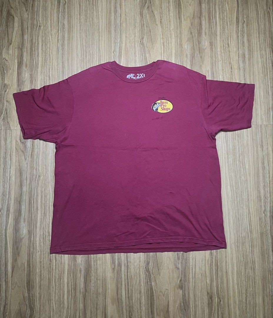Bass Pro Shops Maroon 2XL 27X30 (Category: Tshirts & Polo Shirts ) located in Cebu City. Submitted by guttathreads (Listing ID 1465429787, Image 1). Description: - Brand: Bass Pro Shops - Color: Maroon - Size: 2XL (Regular Fit) -issue has stain below logo - Material: 100% Cotton, Made in Pakistan - Design: Johnny Morris signature logo on front chest, large logo on the back - Condition: Good, with a small ink/stain mark near the front logo.