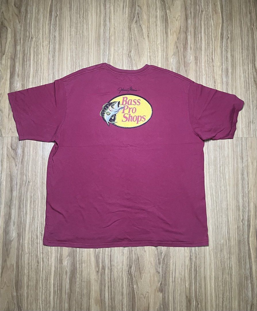 Bass Pro Shops Maroon 2XL 27X30 (Category: Tshirts & Polo Shirts ) located in Cebu City. Submitted by guttathreads (Listing ID 1465429787, Image 2). Description: - Brand: Bass Pro Shops - Color: Maroon - Size: 2XL (Regular Fit) -issue has stain below logo - Material: 100% Cotton, Made in Pakistan - Design: Johnny Morris signature logo on front chest, large logo on the back - Condition: Good, with a small ink/stain mark near the front logo.