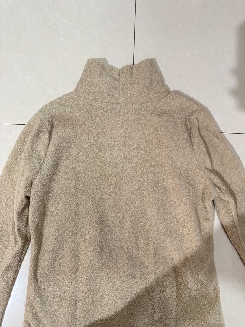 Beige cream high neck fleece sweater pullover (Category: Coats, Jackets and Outerwear) located in Quezon City. Submitted by sweetlyluxe (Listing ID 1465499188, Image 3). Description: - Color: Neutral beige - Material: Soft and fuzzy fleece - Neckline: High mock neck for extra warmth - Fit: Relaxed fit with long sleeves - Style: Great basic for layering with jeans or skirts for winter.