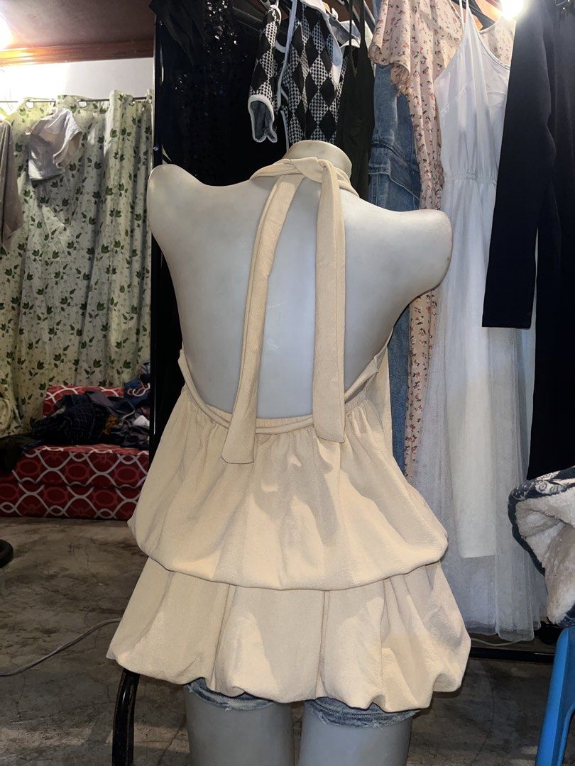 Beige Halter Neck Ruffle Hem Dress (Category: Dresses) located in Cavite. Submitted by bellewii (Listing ID 1465494638, Image 2). Description: - Color: Elegant Beige - Style: Halter neck with high mock collar and sleeveless design - Details: Gathered neckline and double-layered bubble hem silhouette - Fabric: Smooth textured material all over - Closure: Easy zip closure at the back - Condition: Brand new / Excellent (Ready to wear!) - Mode of Pay