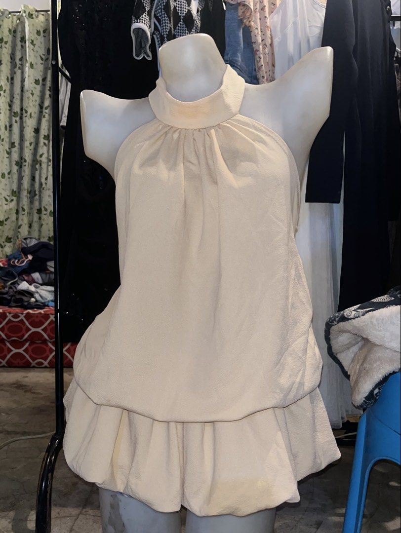 Beige Halter Neck Ruffle Hem Dress (Category: Dresses) located in Cavite. Submitted by bellewii (Listing ID 1465494638, Image 1). Description: - Color: Elegant Beige - Style: Halter neck with high mock collar and sleeveless design - Details: Gathered neckline and double-layered bubble hem silhouette - Fabric: Smooth textured material all over - Closure: Easy zip closure at the back - Condition: Brand new / Excellent (Ready to wear!) - Mode of Pay