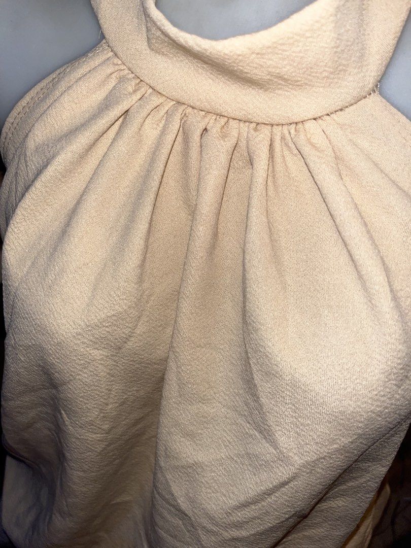 Beige Halter Neck Ruffle Hem Dress (Category: Dresses) located in Cavite. Submitted by bellewii (Listing ID 1465494638, Image 3). Description: - Color: Elegant Beige - Style: Halter neck with high mock collar and sleeveless design - Details: Gathered neckline and double-layered bubble hem silhouette - Fabric: Smooth textured material all over - Closure: Easy zip closure at the back - Condition: Brand new / Excellent (Ready to wear!) - Mode of Pay