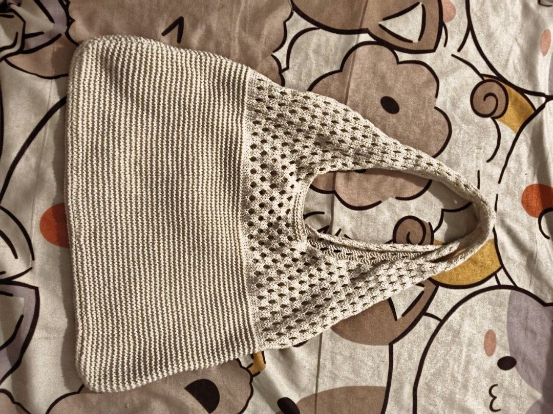 Beige Knit Shoulder Bag (Category: Shoulder Bags) located in Manila. Submitted by ksyoungieberries (Listing ID 1465514956, Image 1). Description: - Color: Versatile beige - Material: Soft woven fabric - Design: Unique textured look with a solid knit left side and open mesh weave on the right and strap - Style: Casual shoulder bag - Usage: Perfect for daily errands, school, or weekend outings.